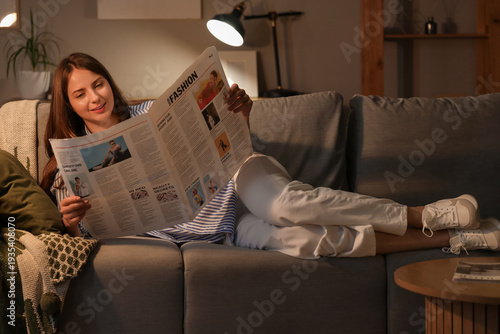 Young woman reading newspap...