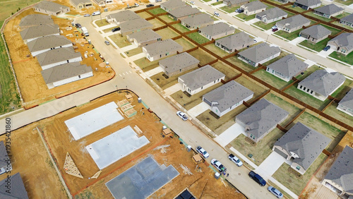 Mixed development block, neighborhood growth at Highpointe Ranch, US-377, Blackjack Rd blends completed homes with active construction zones. Gray roofs, fenced yards, expanding area, Aubrey, TX