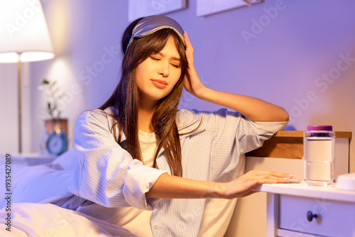 Young woman taking sleeping...