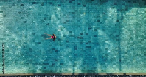Aerial view of a solitary figure floats in a turquoise swimming pool amidst the manicured grounds of Prince Maurice, Prince Maurice, Mauritius.