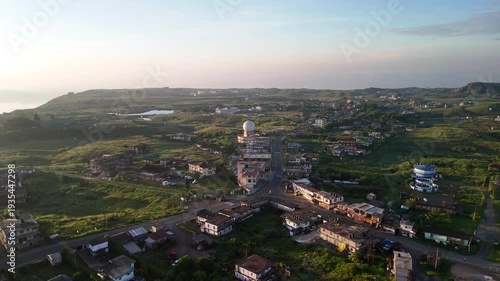 Aerial view of the landscape with a white dome structure nestled among lush green hills and small lake, Shillong, Meghalaya, India.