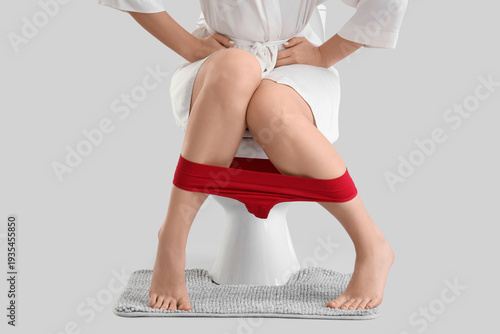 Young woman sitting on toil...