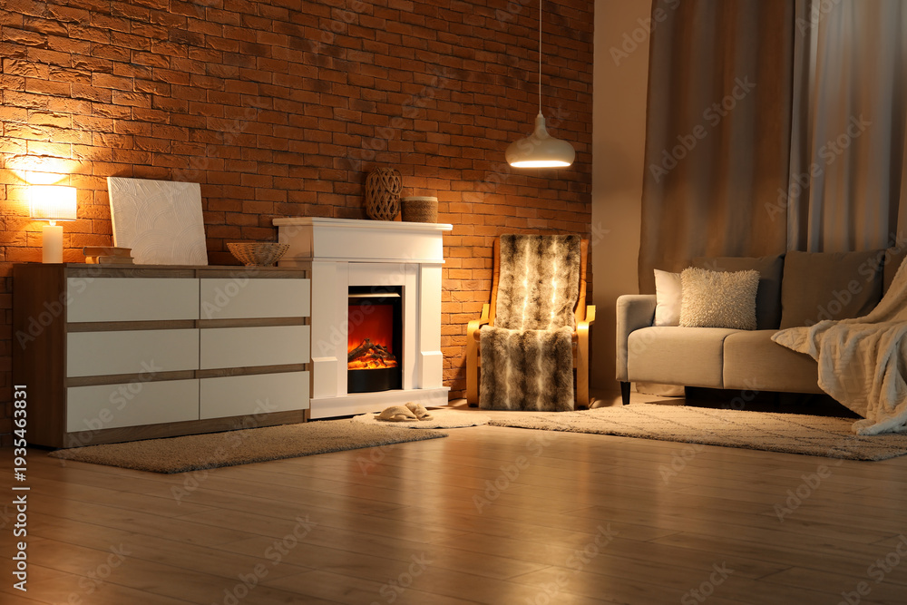 Fototapeta premium Cozy interior of living room with fireplace and glowing lamps in evening
