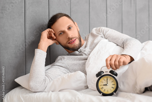 Young man in pajamas with a...