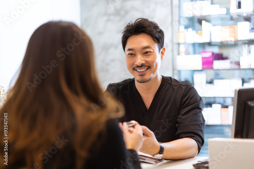 esthetician consulting male client about pore care routine, beauty clinic reception area, bright neutral lighting, professional friendly atmosphere