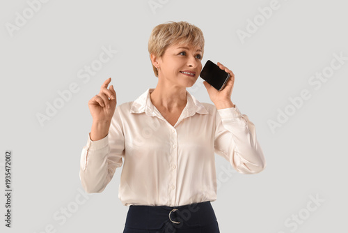 Mature businesswoman talkin...