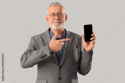 Senior businessman pointing...