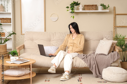 Young pregnant woman using ...