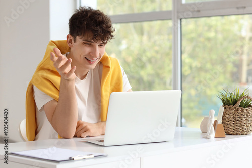 Young man video chatting wi...