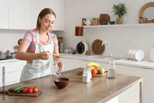 Young woman pouring chia se...