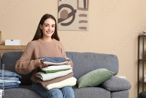 Young woman with stack of c...