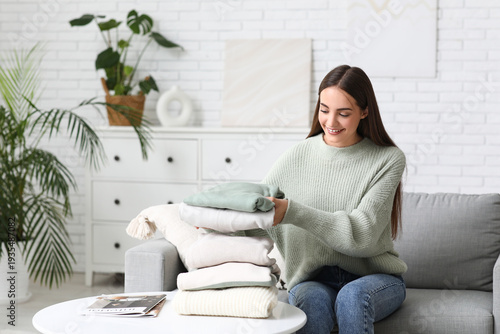 Young woman with stack of w...