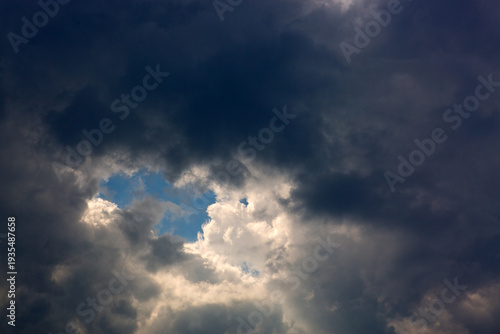 Gray rain clouds and blue sky in summer day.