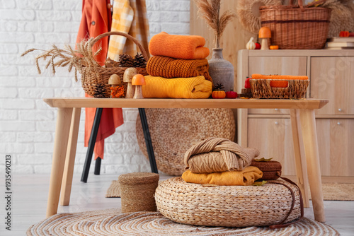 Stacks of stylish clothes w...