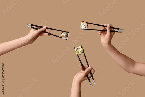 Female hands holding chopst...