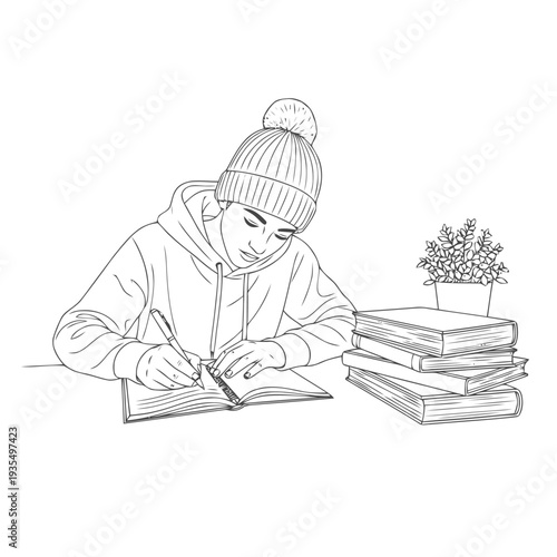 Student wearing a knit beanie draws notes in an open book next to a stack of textbooks and a potted plant.