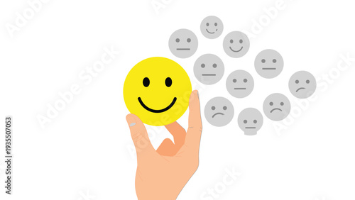 Human hand picking a bright yellow happy smiley face from a group of grey sad and neutral faces representing positive choice and mental health.