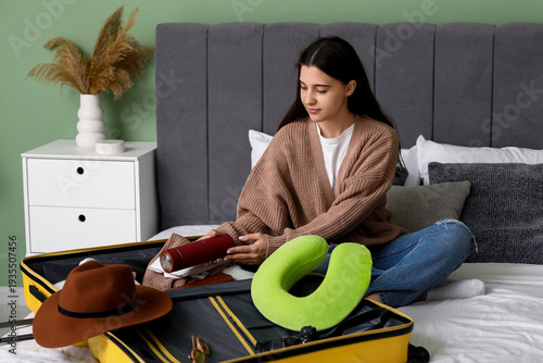 Young woman packing thermos...