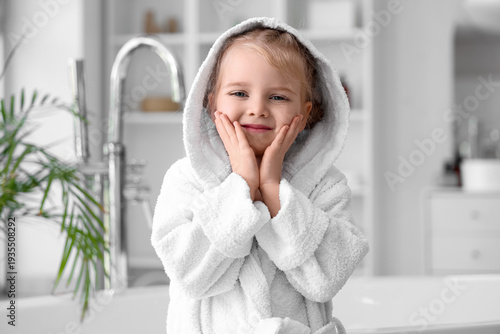 Cute little girl in bathrob...
