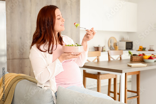 Young pregnant woman eating...
