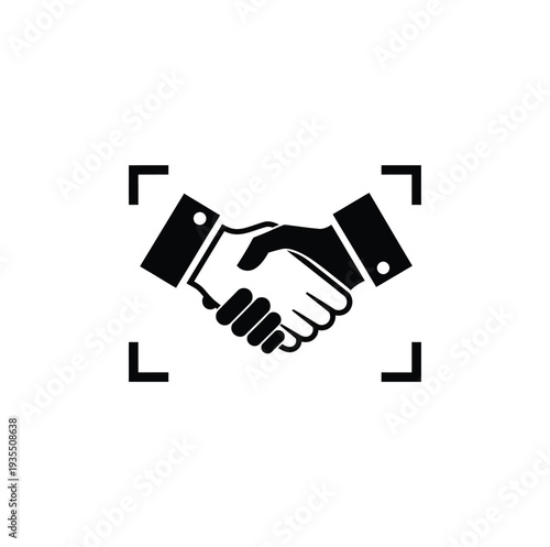 Two individuals engaging in a handshake symbolizing partnership and agreement in a professional setting
