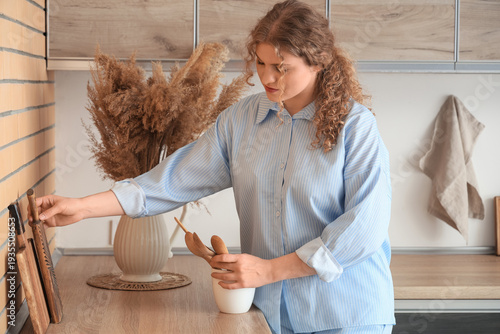 Young woman with utensils i...
