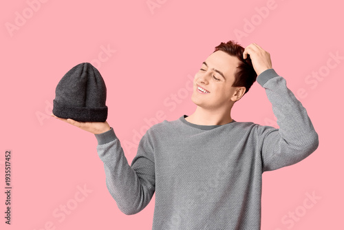 Young man with hat in his h...