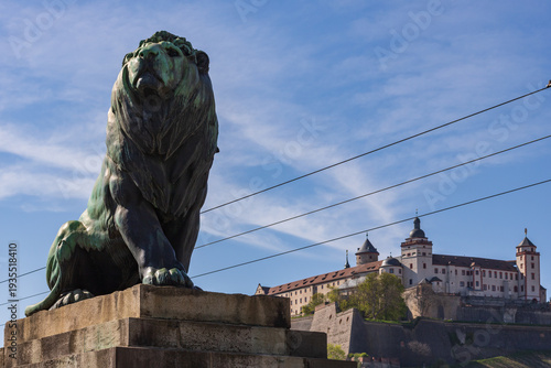 Lion Statue at Löwenbrücke with Marienberg Fortress in Würzburg, Germany