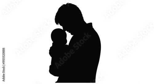 Silhouette of a father tenderly holding a baby in his arms