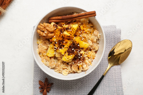 Bowl with tasty oatmeal, ap...