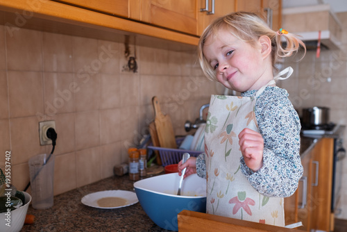 Independent preschooler: little 4 year old girl baking a homemade pie alone in a cozy kitchen