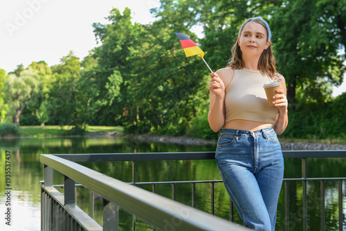 Young woman with flag of Ge...