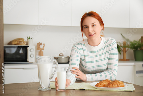 Young redhead woman with gl...