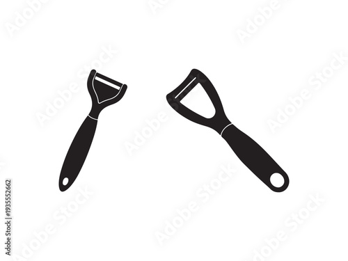 Two black vegetable peelers with handles and holes for hanging on a white background  kitchen utensils for peeling fruits and vegetables