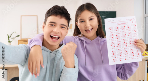 Happy teenage students with...