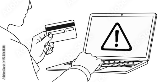 Hand holding credit card, looking at laptop with warning symbol