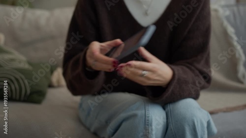 Handheld shot of cheerful adult Caucasian lady demonstrating contraceptive pills and smartphone screen with menstruation calendar while communicating indoors