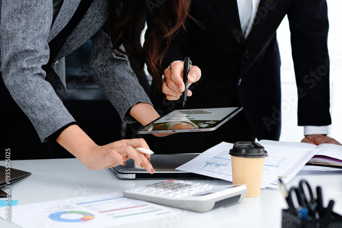 Close up shot business people team meeting in conference room in company. Businessman pointing pen at tablet on the table