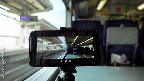 Cellphone on a tripod films a train ride, showing both inside and outside the train