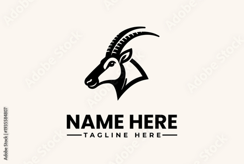 Black and white illustration of an antelope head logo with 'NAME HERE' and 'TAGLINE HERE' text on a beige background.