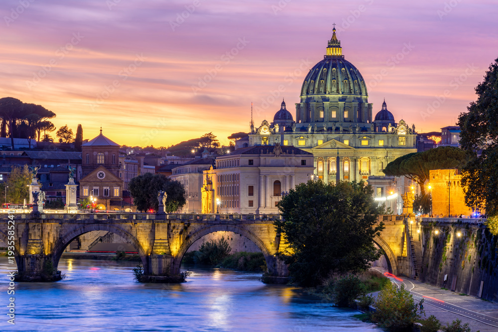 Fototapeta premium St. Peter's basilica dome in Vatican and St. Angel bridge over Tiber river at sunset in Rome, Italy