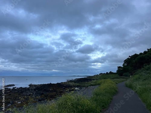 Coastal path along the sea under an overcast sky near Bangor, Northern Ireland, United Kingdom, June 2025