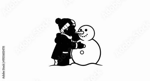 Child dressed in winter clothes constructs a snowman