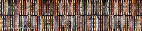 a collection of vintage cassette tapes lined up neatly, showcasing a variety of colored plastic cases