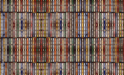 a collection of vintage cassette tapes lined up neatly, showcasing a variety of colored plastic cases