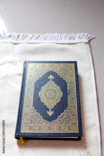 Wallpaper Mural Holy Quran on a prayer mat, capturing a serene and peaceful atmosphere for Islamic worship Torontodigital.ca