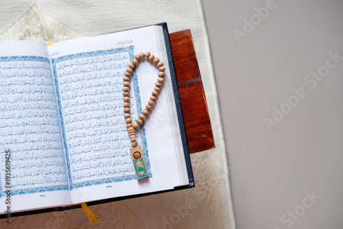 Wallpaper Mural The holy Quran and prayer beads or tasbih on a rehal, capturing a serene atmosphere of devotion Torontodigital.ca
