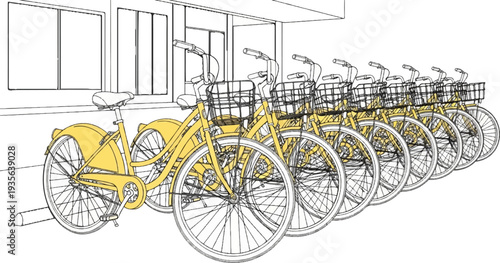Yellow bicycles with baskets lined up against a building