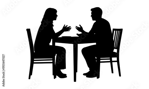 Silhouette of a man and woman sitting at a table having a conversation
