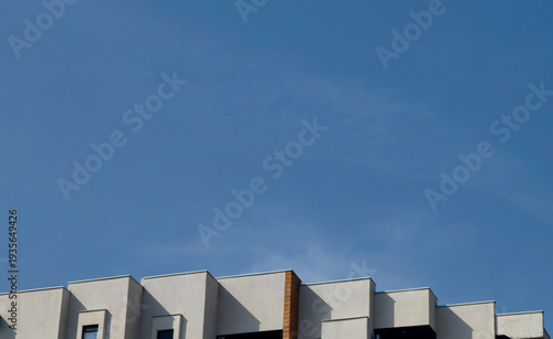 Rooftop Lines – Minimal Architecture Against Blue Sky.